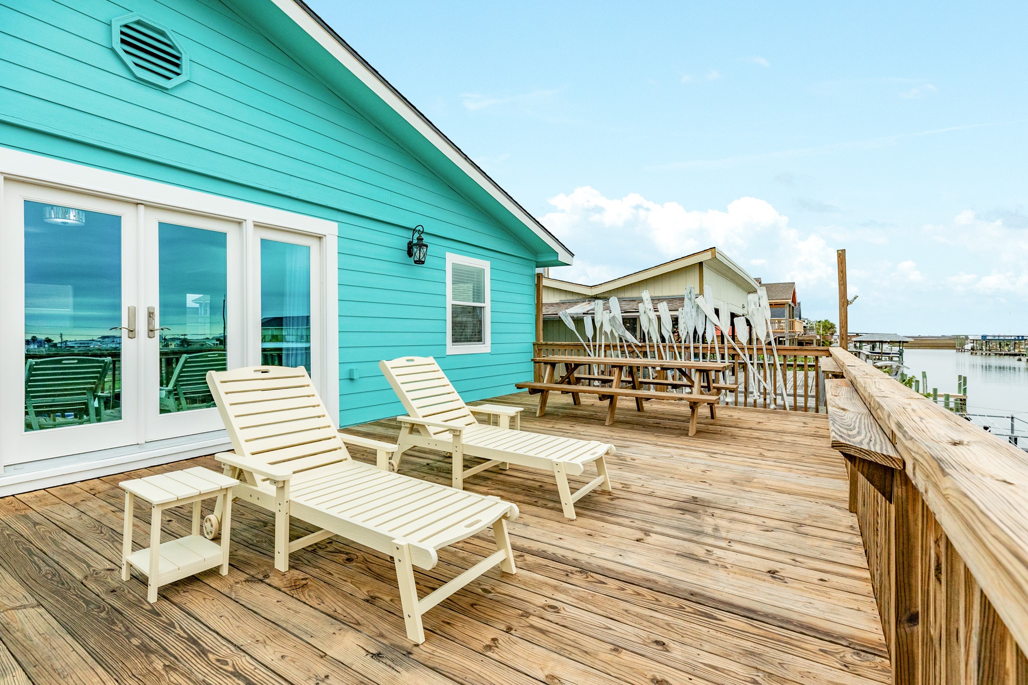 306 Pompano Lane Surfside Beach, TX 77541 - Photo 9 of 37 a view of a balcony with chairs and wooden floor