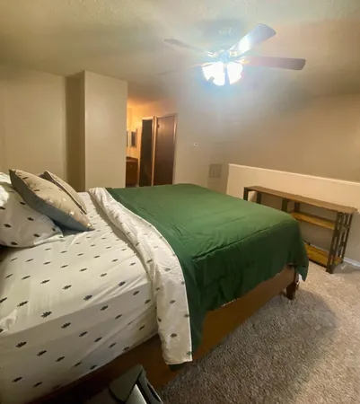 a bedroom with a bed and a chandelier