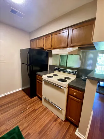 a kitchen with stainless steel appliances a stove a refrigerator and a sink
