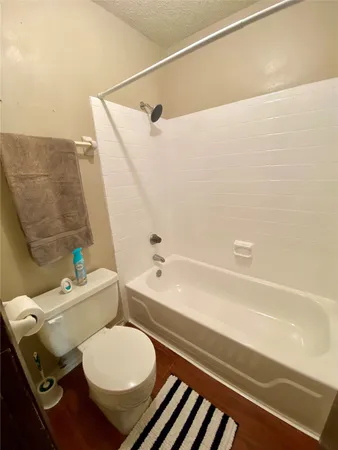 a bathroom with a toilet and a bathtub