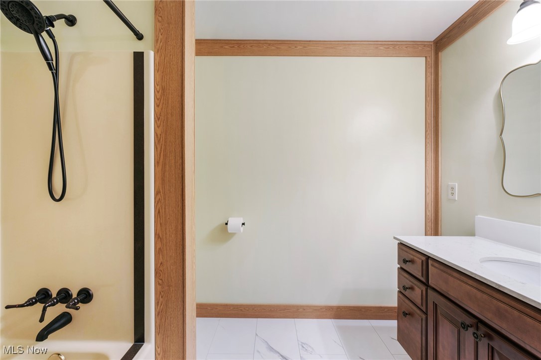 7059 Stewart Sharon Road Hubbard, OH 44425 - Photo 32 of 49 Full bathroom featuring vanity, baseboards, and washtub / shower combination