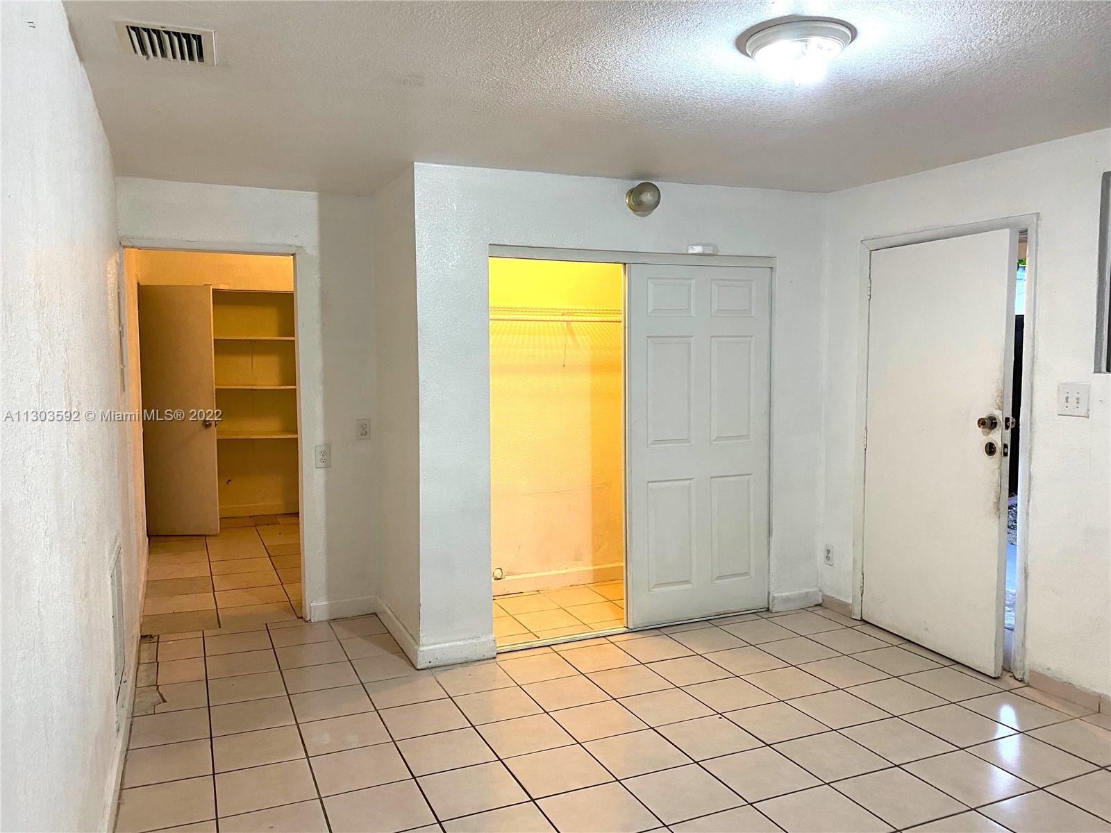 4763 Northwest 3rd Street, Unit 1A Miami, FL 33126 - Photo 7 of 14 a view of a room with a wardrobe space