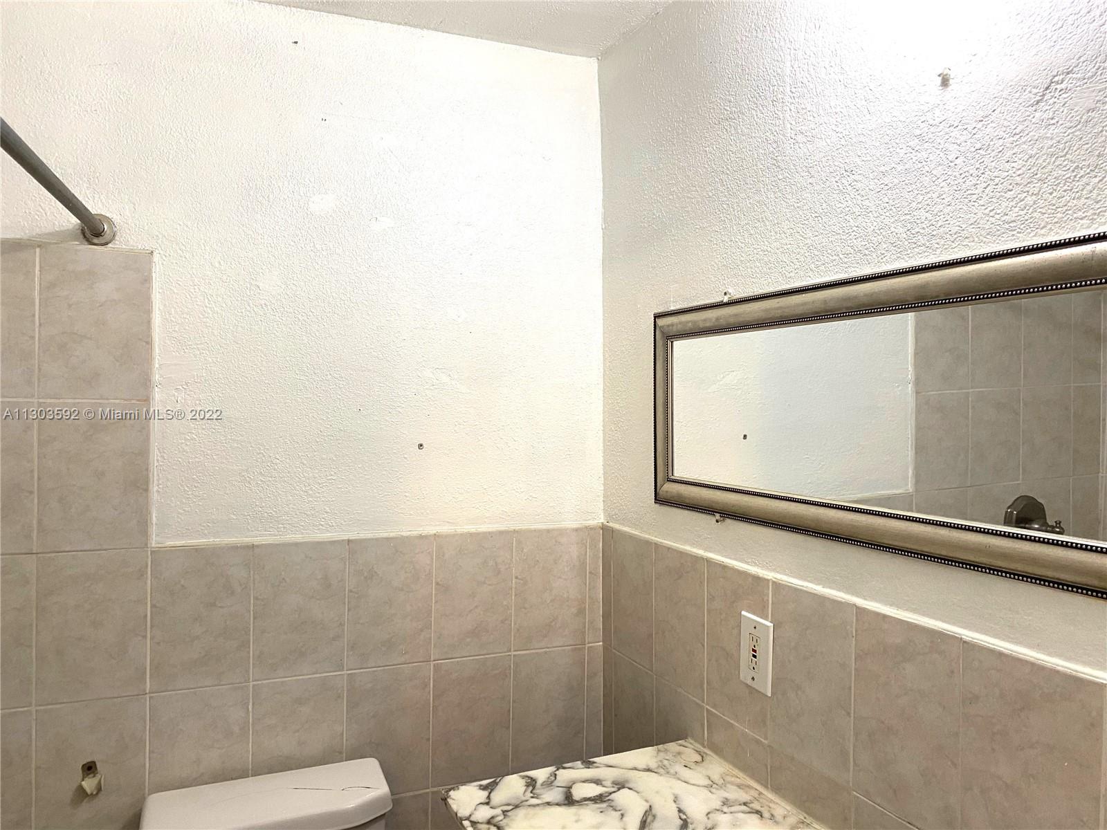 4763 Northwest 3rd Street, Unit 1A Miami, FL 33126 - Photo 10 of 14 a bathroom with a shower and a sink