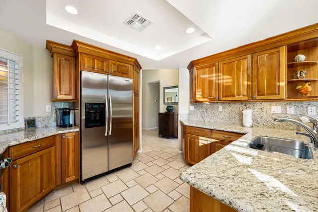 a kitchen with stainless steel appliances granite countertop a sink stove and cabinets