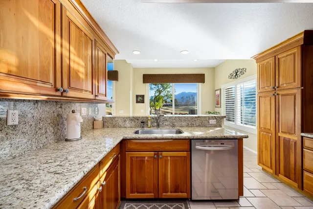 a spacious bathroom with a granite countertop sink mirror and shower