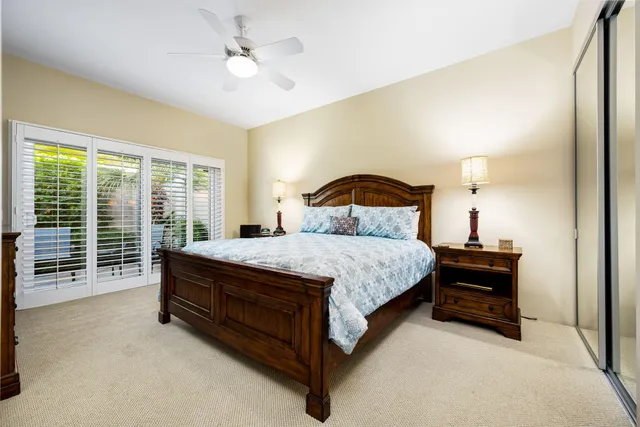 a bathroom with a granite countertop sink mirror vanity and toilet