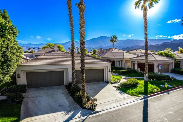 a view of a street with palm trees