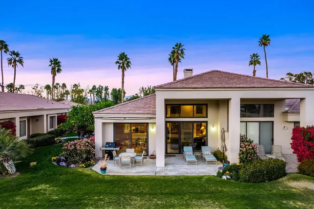 a view of a house with backyard porch and sitting area