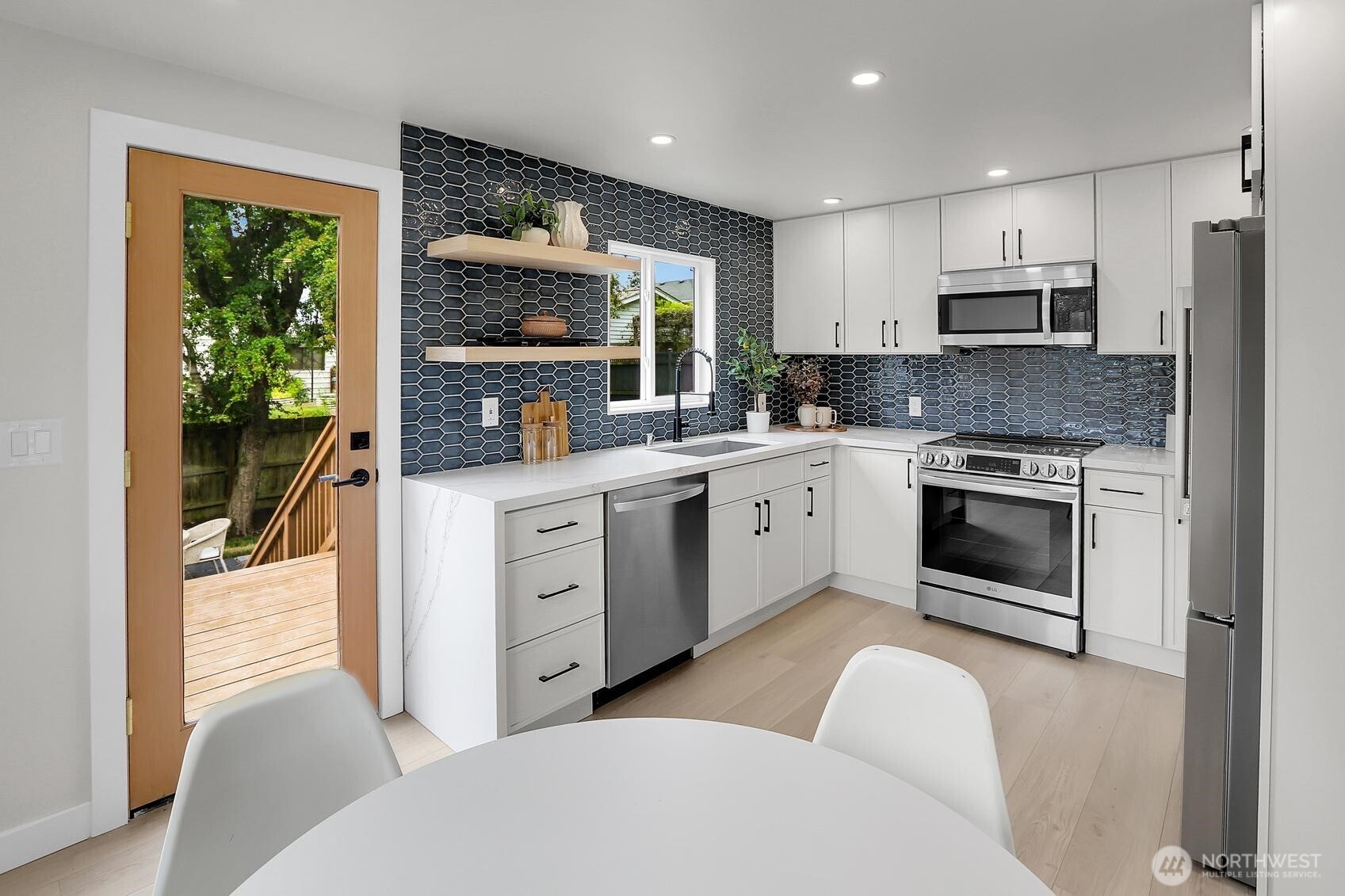 8421 39th Avenue Southwest Seattle, WA 98136 - Photo 6 of 24 a open kitchen with stainless steel appliances granite countertop a stove a sink and a refrigerator