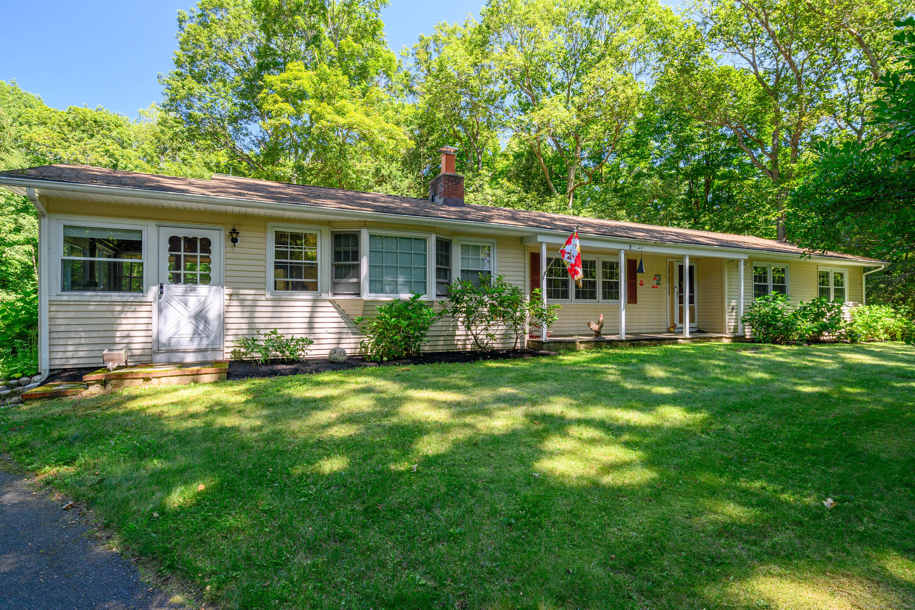 a front view of house with yard and green space