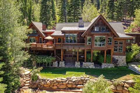 a front view of a house with a yard and potted plants