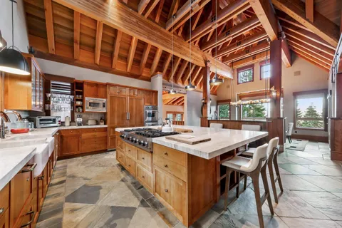 a kitchen with stainless steel appliances a stove a sink and a refrigerator