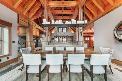 a dining room with furniture a rug and a chandelier