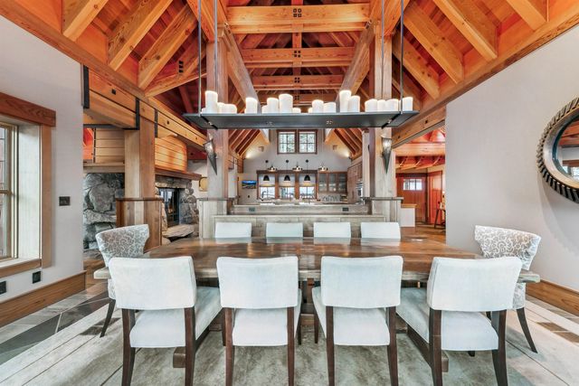 a dining room with furniture a rug and a chandelier