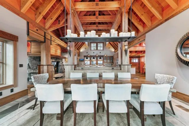 a dining room with furniture a rug and a chandelier