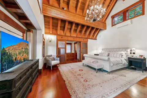 a bedroom with furniture and a large window