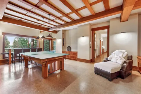 a living room with furniture a table tennis pool table and chairs