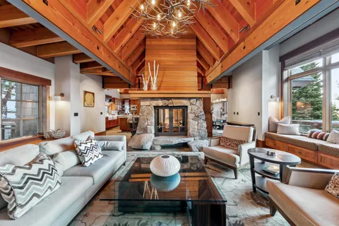 a living room with furniture fireplace and a large window