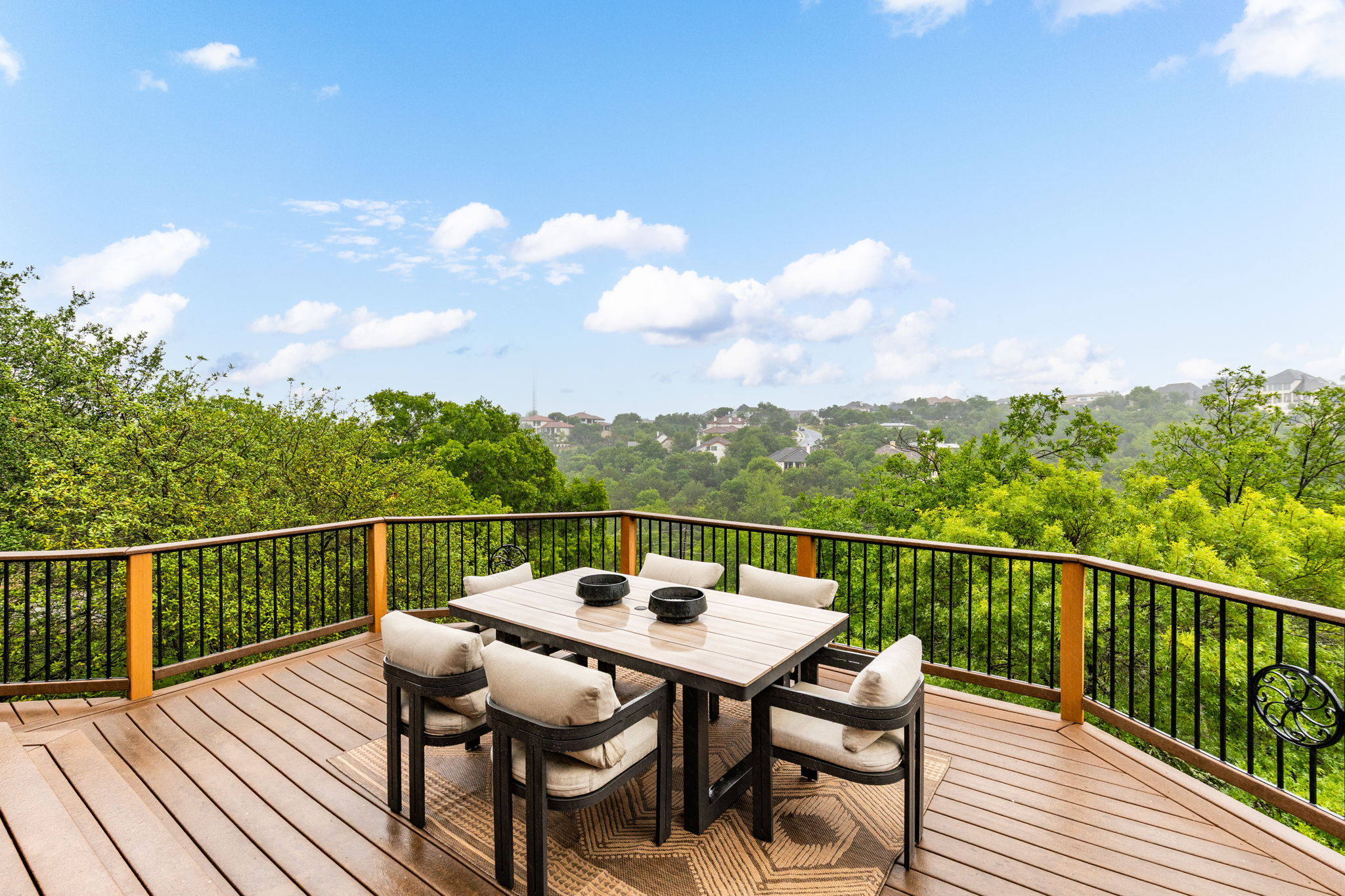 2807 Round Table Road Austin, TX 78746 - Photo 12 of 40 Spacious outdoor deck featuring wood-finish flooring and a black metal railing with wood posts