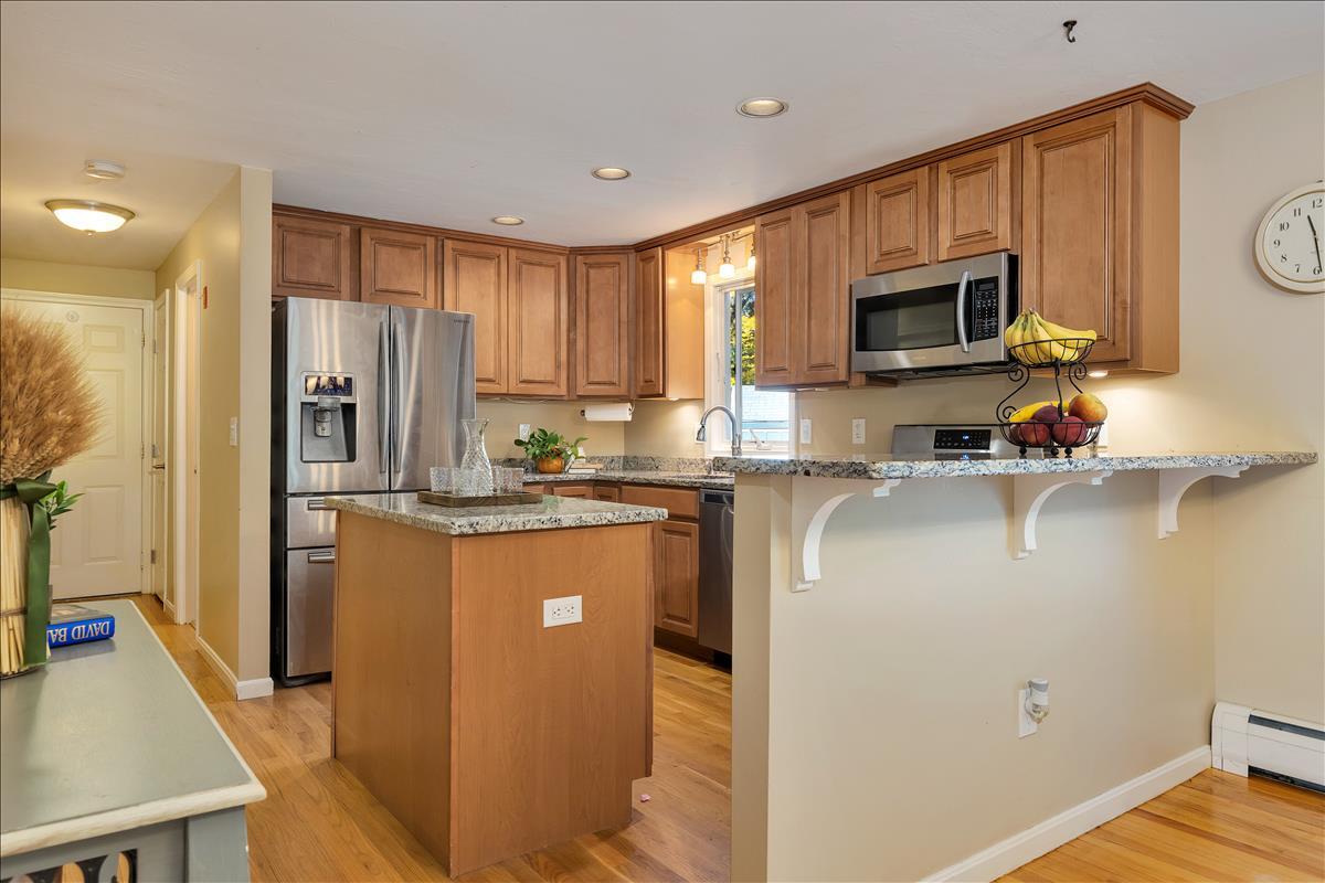 524 Prince Hinckley Road Centerville, MA 02632 - Photo 16 of 43 a kitchen with stainless steel appliances granite countertop a refrigerator stove microwave and sink