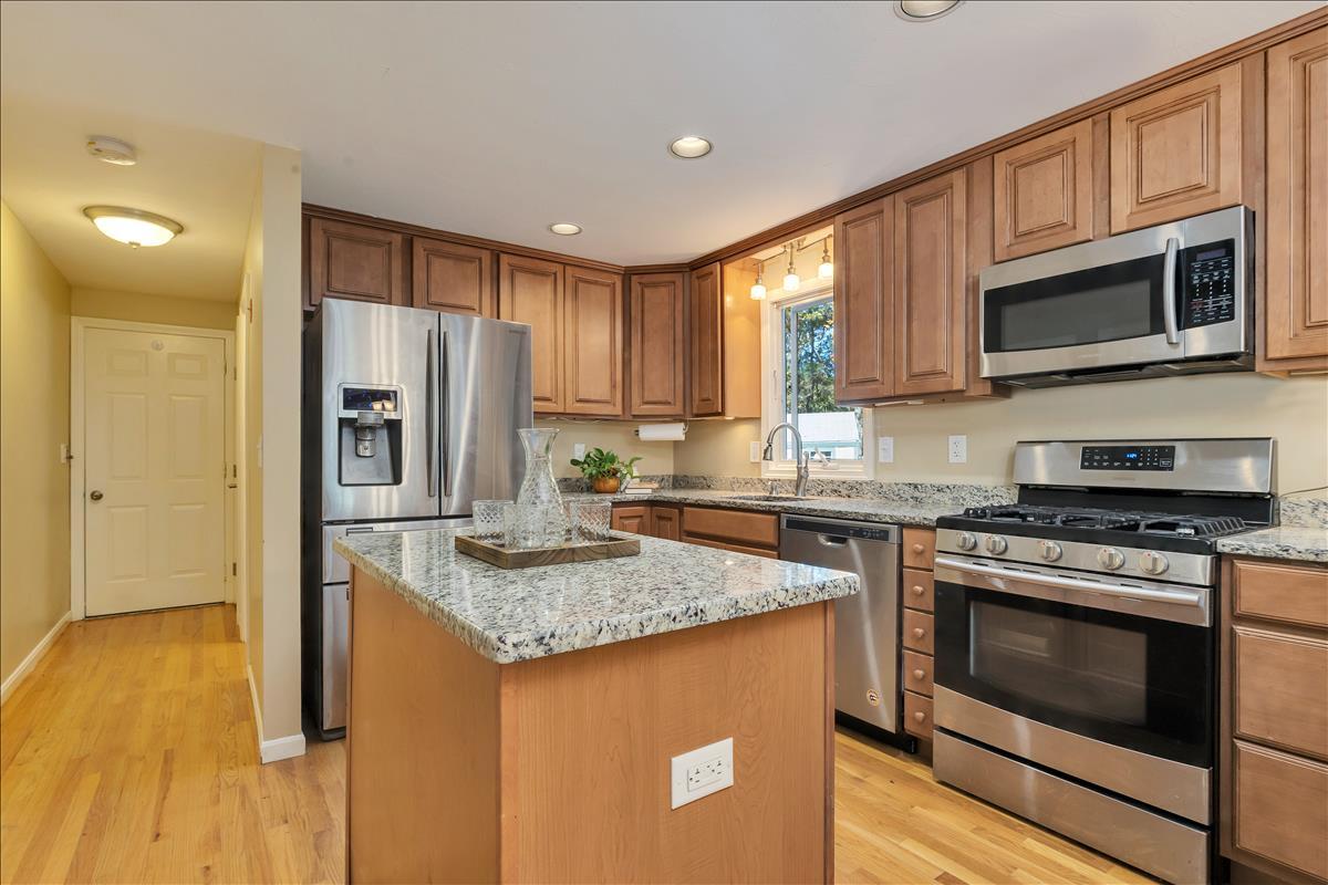 524 Prince Hinckley Road Centerville, MA 02632 - Photo 17 of 43 a kitchen with stainless steel appliances granite countertop a stove a sink and a microwave