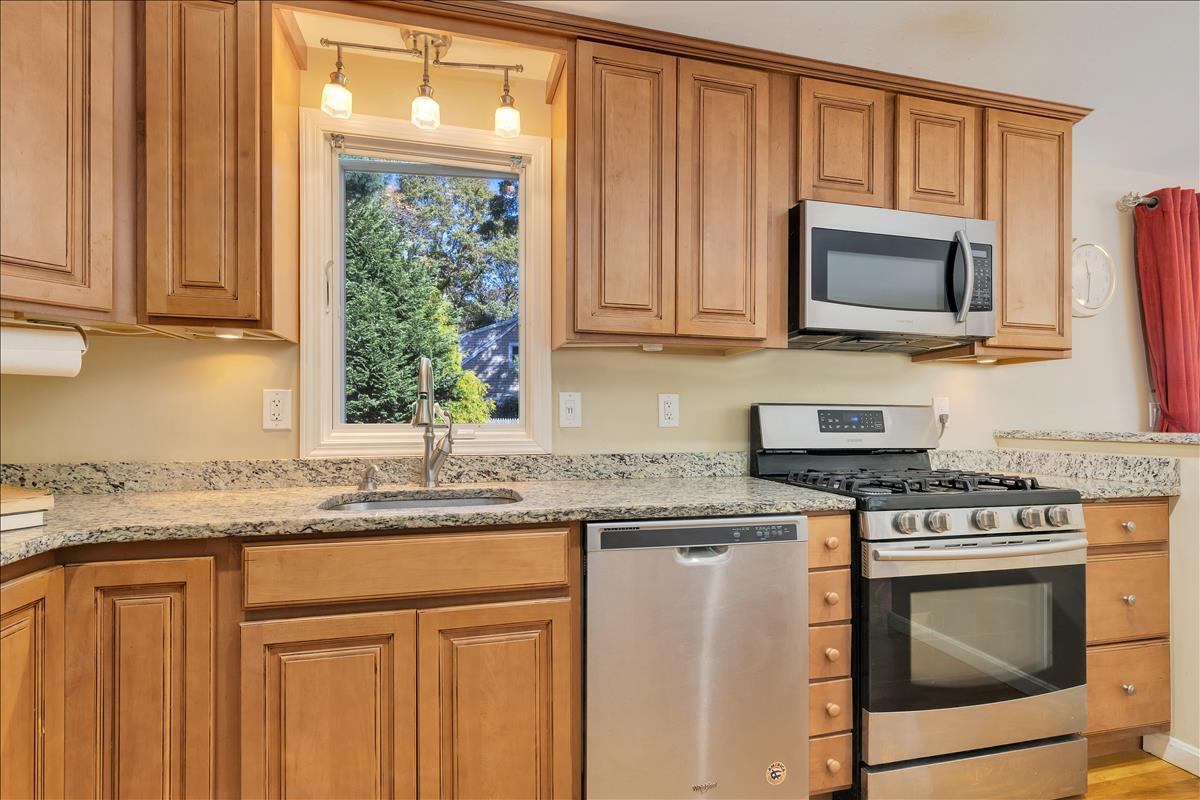524 Prince Hinckley Road Centerville, MA 02632 - Photo 21 of 43 a kitchen with granite countertop a stove sink and microwave