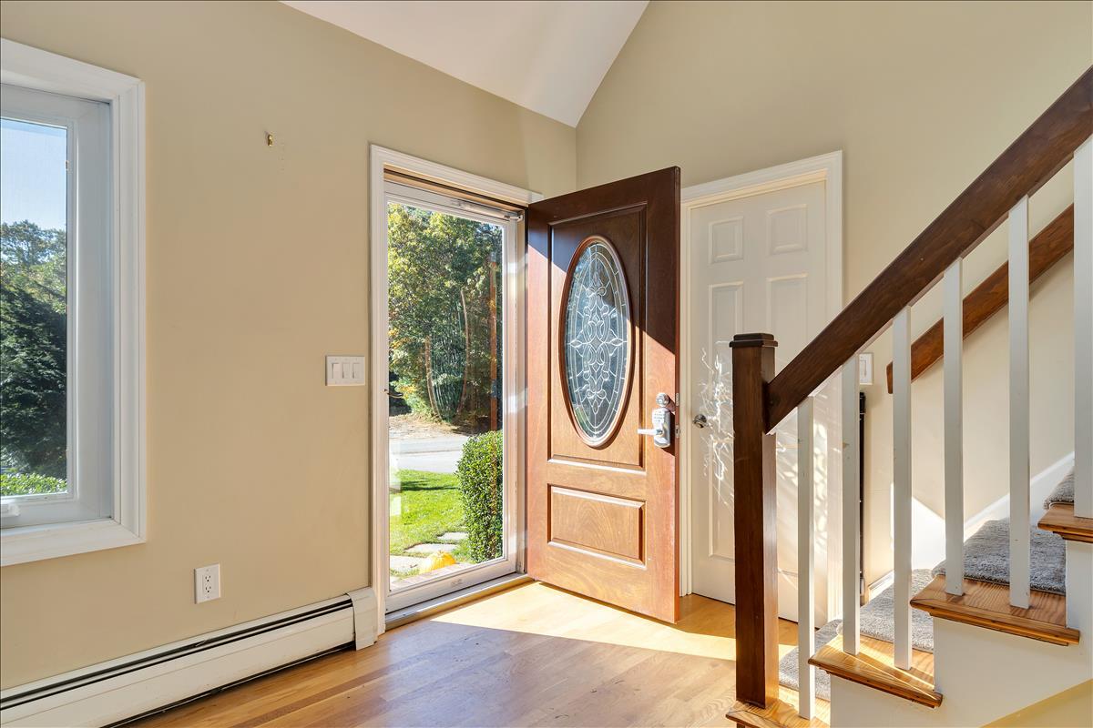 524 Prince Hinckley Road Centerville, MA 02632 - Photo 7 of 43 a view of a hallway with wooden floor and windows