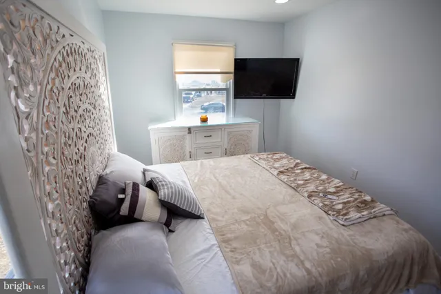 a bedroom with a bed and a flat screen tv