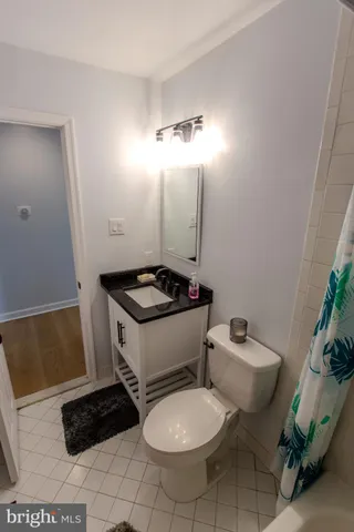 a bathroom with a toilet and a mirror