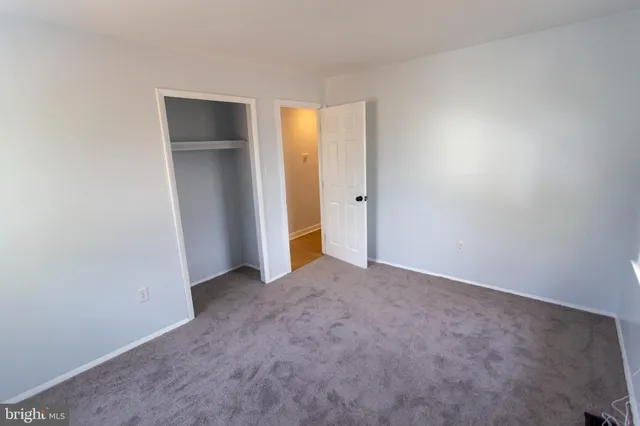 an empty room with closet and a window