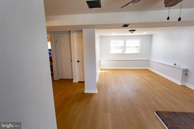wooden floor in an empty room with a window