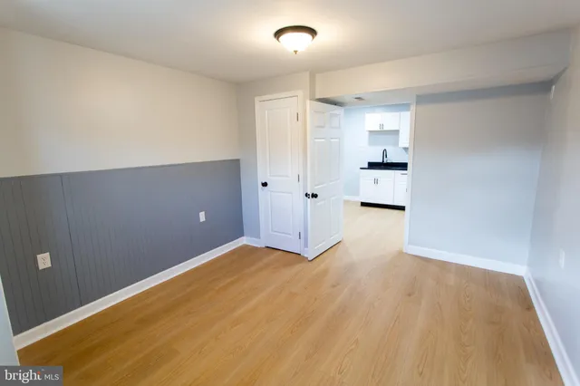a view of empty room with wooden floor