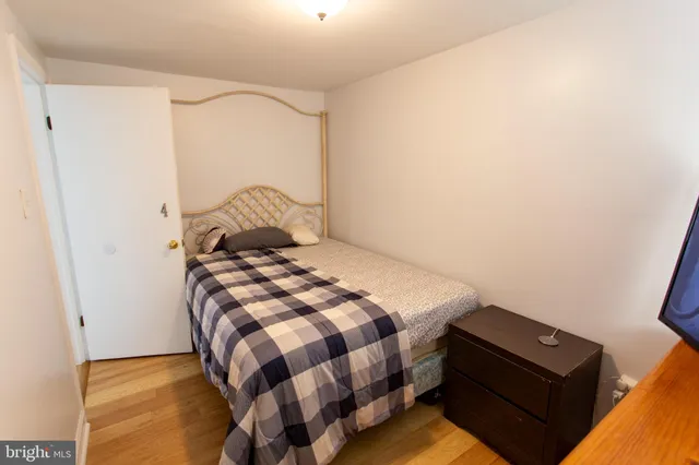 a bedroom with a bed and a night stand