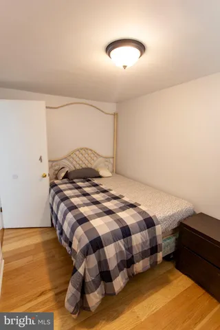 a bedroom with a bed and a night stand