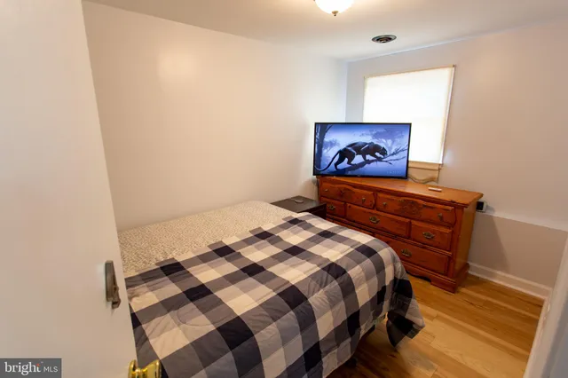 a bedroom with a bed and a painting on the wall