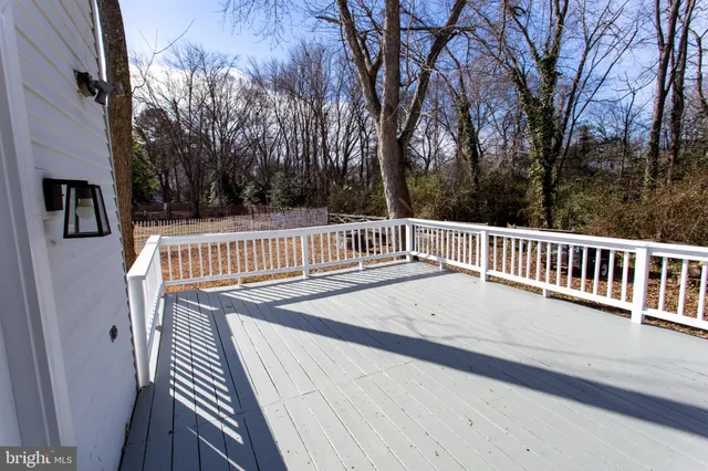 a view of balcony with wooden floor and fence