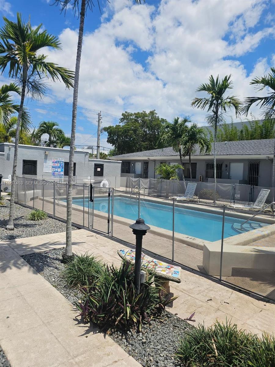 a view of a swimming pool with a bench