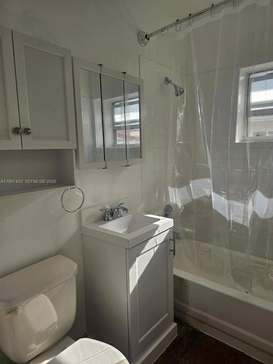 3475 Southwest 1st Avenue, Unit 14 Miami, FL 33145 - Photo 11 of 22 a bathroom with a sink a toilet and shower