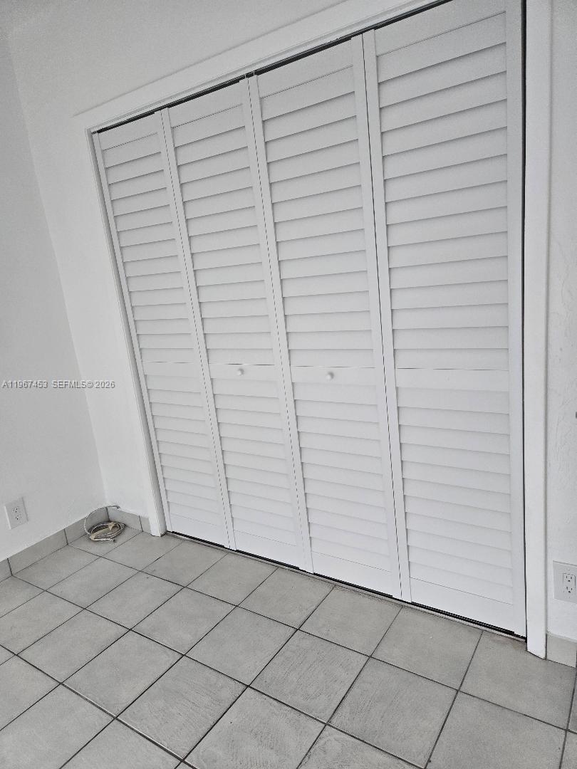 3475 Southwest 1st Avenue, Unit 14 Miami, FL 33145 - Photo 14 of 22 an empty room with a wooden door