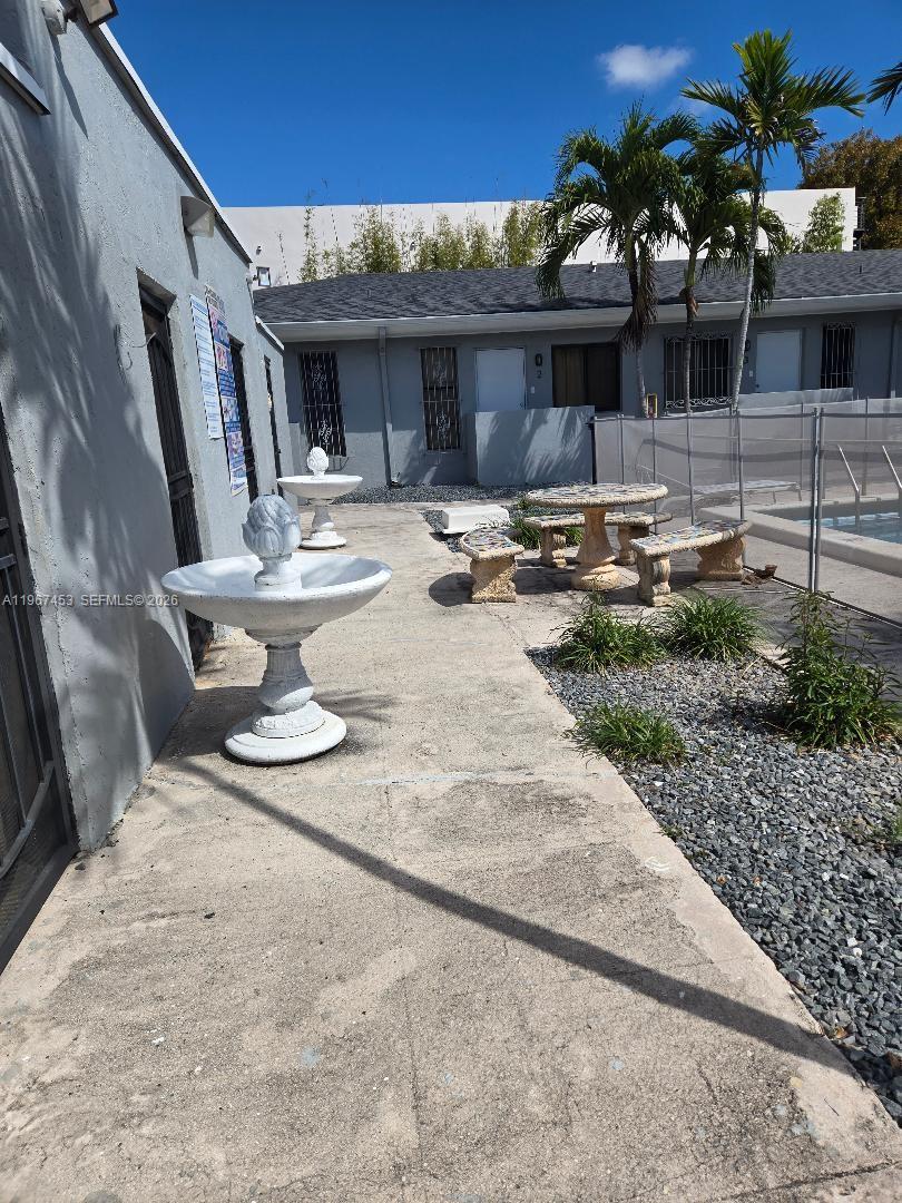 3475 Southwest 1st Avenue, Unit 14 Miami, FL 33145 - Photo 18 of 22 a view of the patio with couches and table and chairs