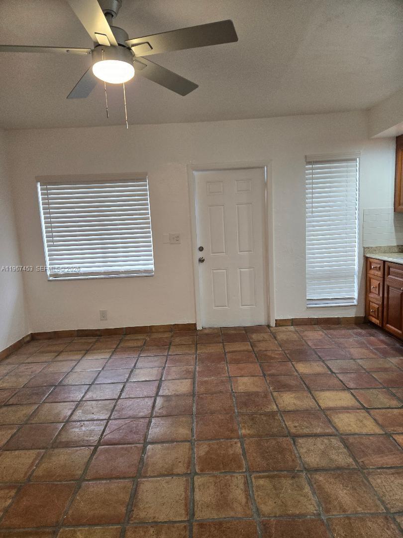 3475 Southwest 1st Avenue, Unit 14 Miami, FL 33145 - Photo 5 of 22 a view of an empty room and window and chandelier fan