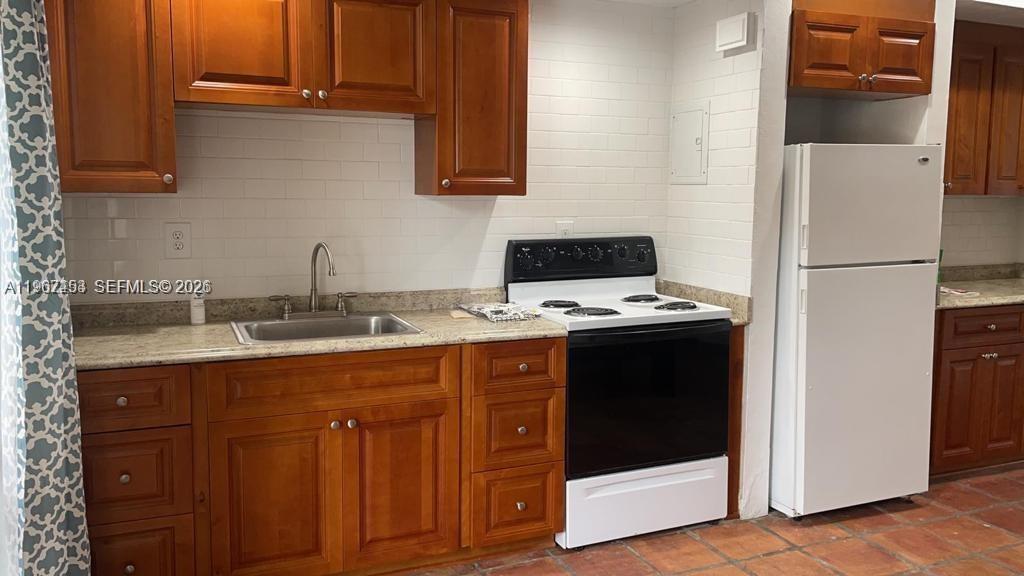 3475 Southwest 1st Avenue, Unit 14 Miami, FL 33145 - Photo 7 of 22 a kitchen with a refrigerator and a sink