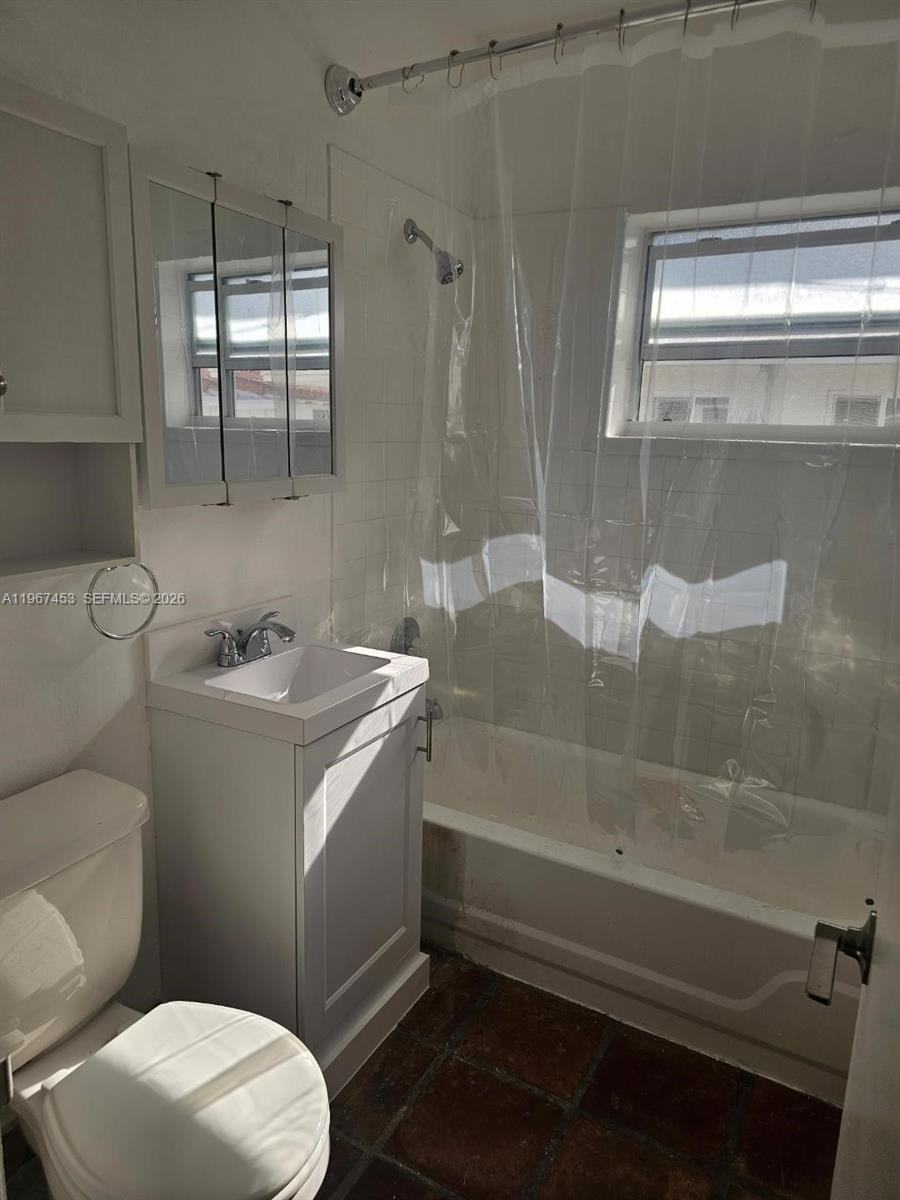 3475 Southwest 1st Avenue, Unit 14 Miami, FL 33145 - Photo 10 of 22 a bathroom with a sink a toilet and shower