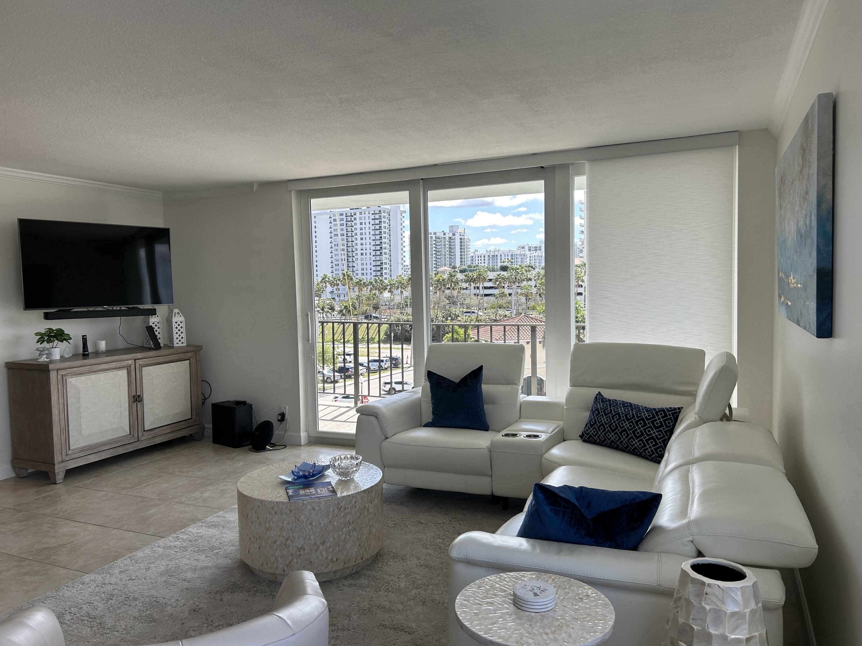 3233 Northeast 32nd Avenue, Unit 503 Fort Lauderdale, FL 33308 - Photo 13 of 15 a living room with furniture and a flat screen tv