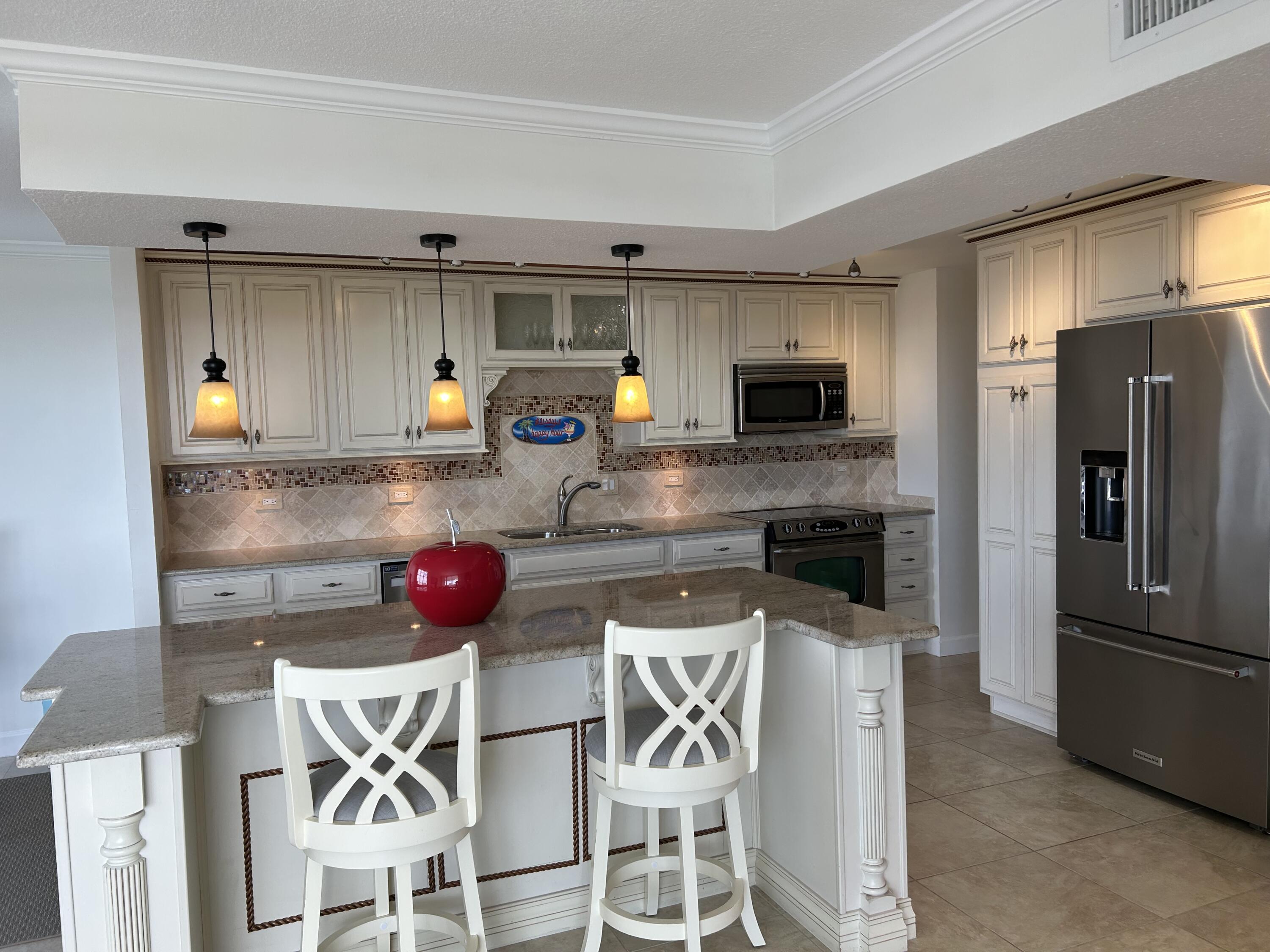 3233 Northeast 32nd Avenue, Unit 503 Fort Lauderdale, FL 33308 - Photo 15 of 15 a kitchen with stainless steel appliances a stove a sink and a refrigerator