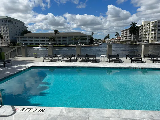 a view of a swimming pool with outdoor seating