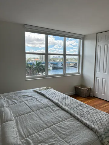 a bedroom with a bed and a window