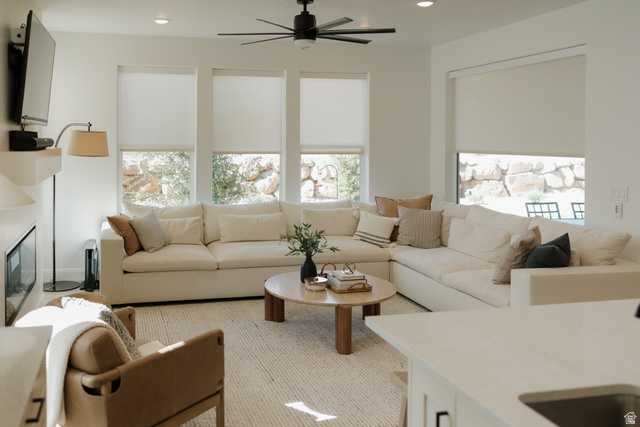629 Spring Lily Drive St. George, UT 84790 - Photo 5 of 50 Open-concept living space featuring a modern linear fireplace, multiple large windows, recessed lighting, and a ceiling fan