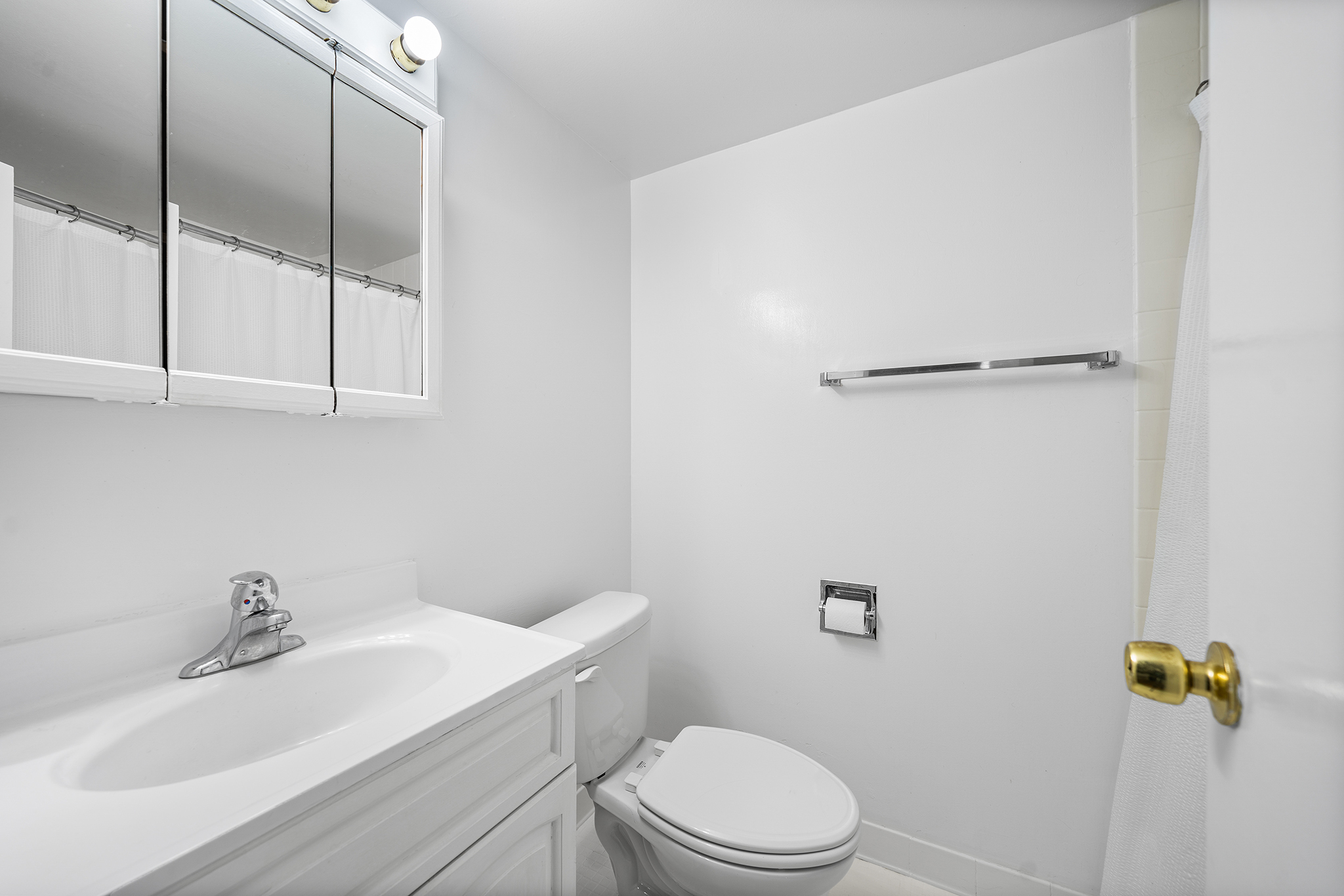 350 East 62nd Street, Unit 1M Manhattan, NY 10065 - Photo 11 of 18 a bathroom with a sink a toilet and vanity