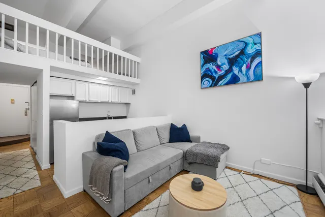 a living room with furniture and a rug